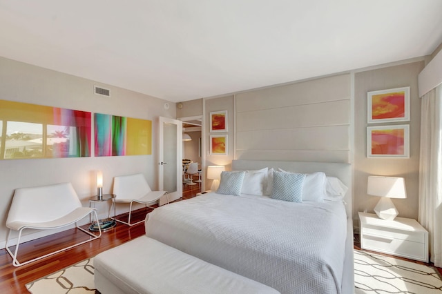 bedroom with wood finished floors and visible vents