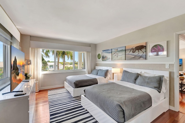 bedroom featuring light wood-style floors and baseboards