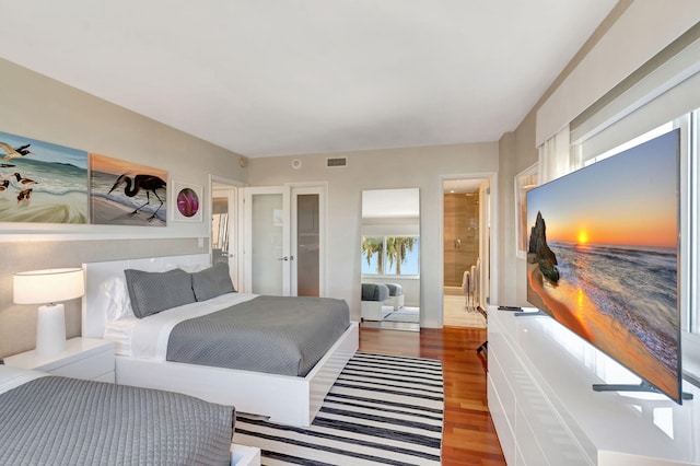 bedroom with wood finished floors and visible vents