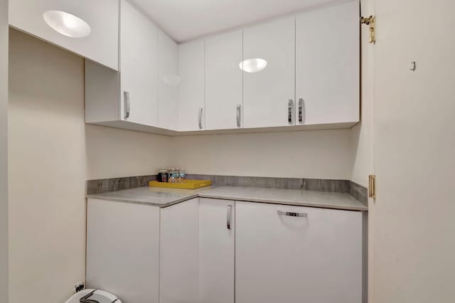 kitchen with white cabinetry and light countertops