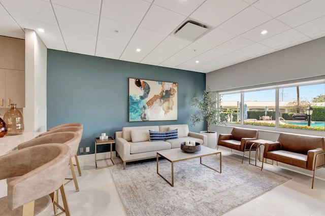 living room featuring visible vents, a drop ceiling, and recessed lighting