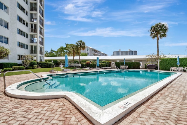 community pool with a patio area