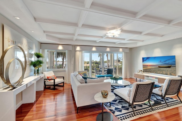 living room with beam ceiling, coffered ceiling, and wood finished floors