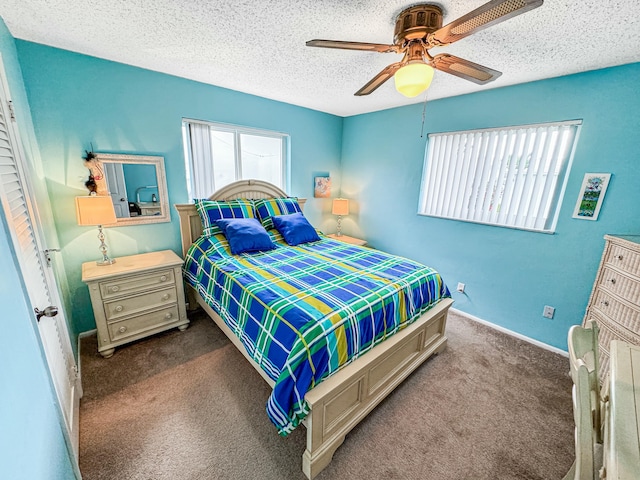 carpeted bedroom featuring baseboards, a ceiling fan, and a textured ceiling