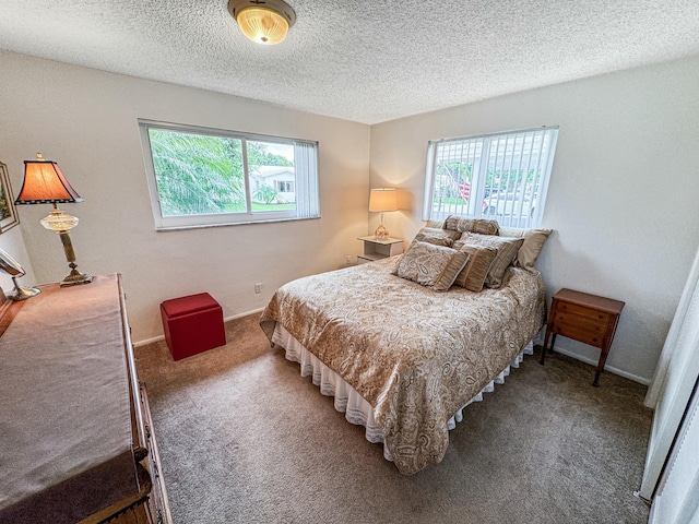 carpeted bedroom featuring a textured ceiling, multiple windows, and baseboards