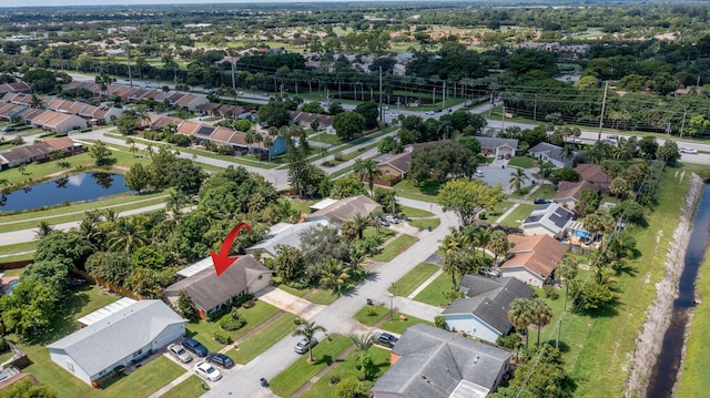 drone / aerial view with a residential view and a water view