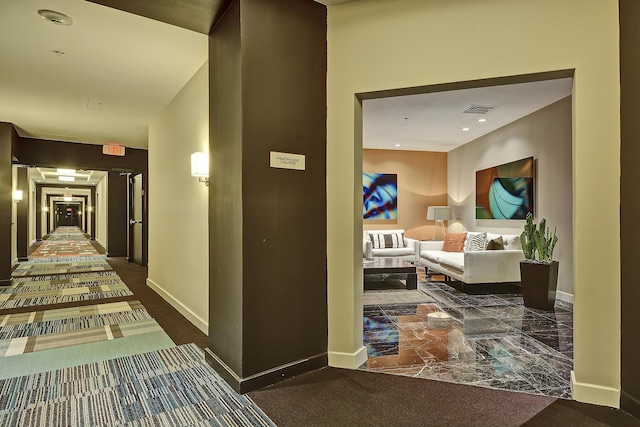 hallway featuring marble finish floor, visible vents, and baseboards