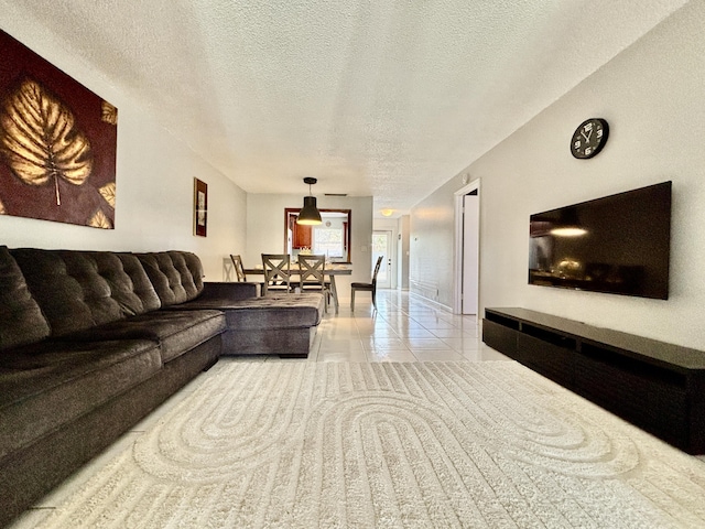 living room featuring a textured ceiling and light tile patterned flooring