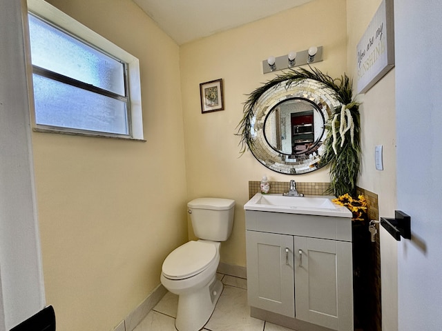 bathroom with vanity, tile patterned flooring, toilet, and baseboards