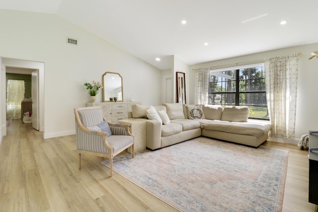 living room featuring high vaulted ceiling, light wood-style flooring, visible vents, and recessed lighting