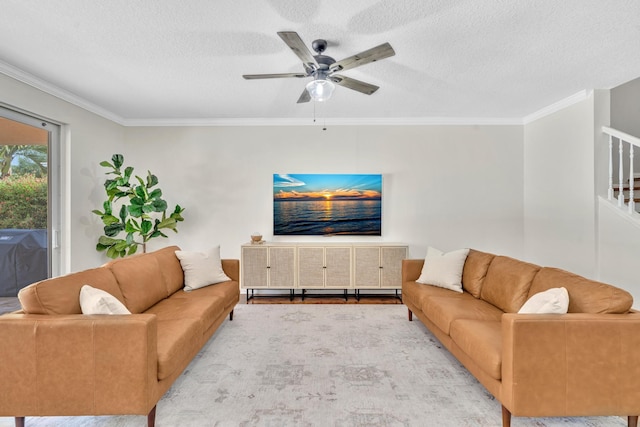 living area featuring a textured ceiling, a ceiling fan, and crown molding