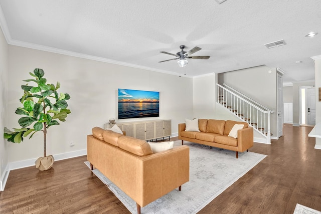 living room with visible vents, crown molding, stairway, and wood finished floors