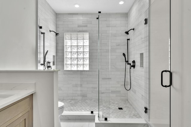 full bath featuring a shower stall, toilet, and vanity