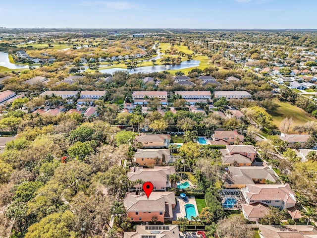 drone / aerial view featuring a water view and a residential view