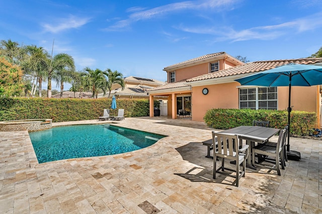 view of pool featuring a fenced in pool, outdoor dining area, a patio, and an in ground hot tub