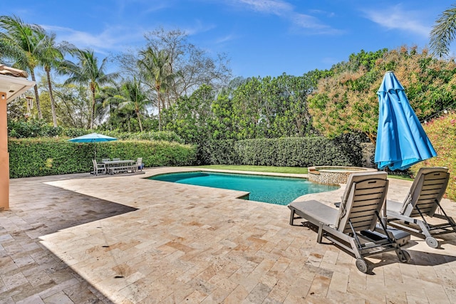 view of swimming pool with a pool with connected hot tub and a patio