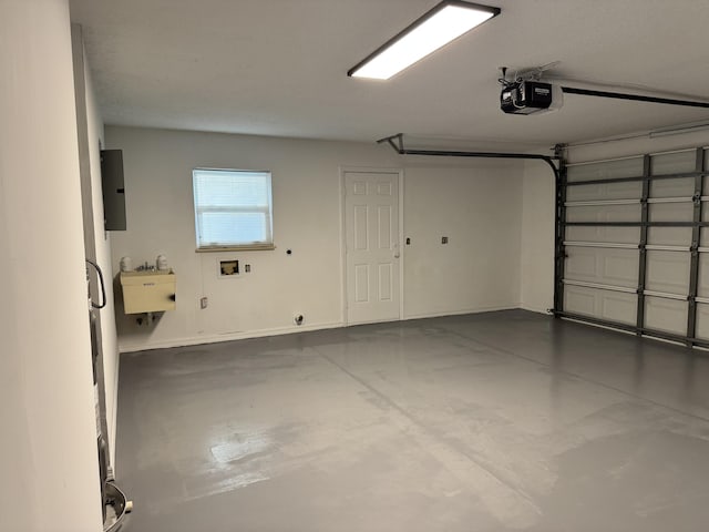 garage featuring a sink, electric panel, a garage door opener, and baseboards