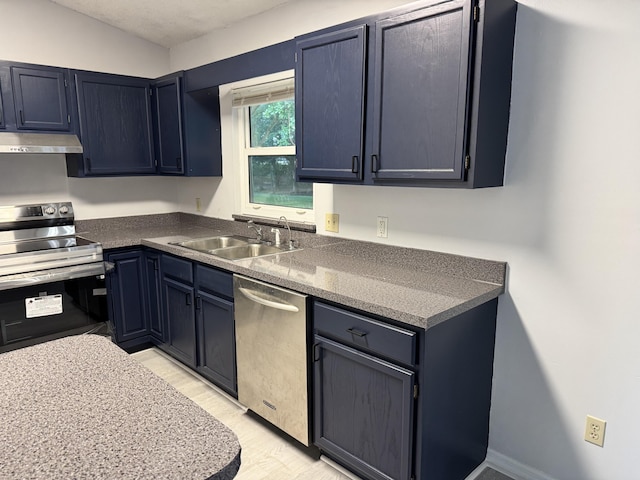 kitchen with blue cabinets, stainless steel appliances, under cabinet range hood, a sink, and light wood-type flooring