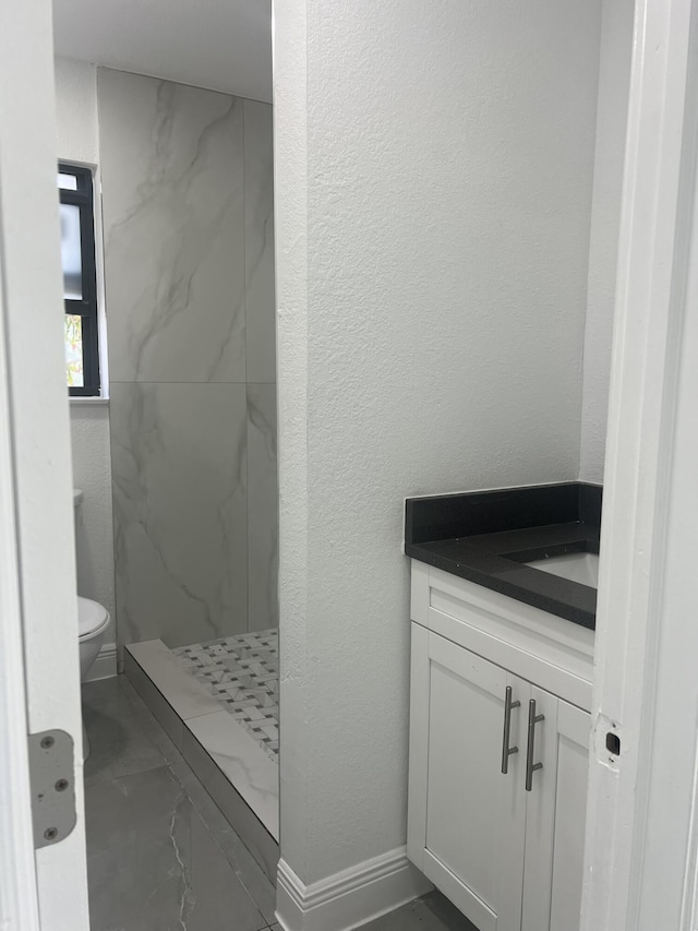 410 S D St, Lake Worth Beach, FL 33460 - full bath featuring vanity, toilet, a textured wall, and a marble finish shower