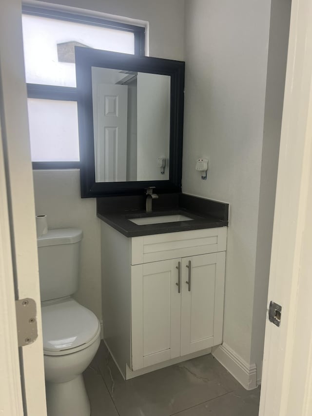 410 S D St, Lake Worth Beach, FL 33460 - half bathroom with toilet, marble finish floor, baseboards, and vanity