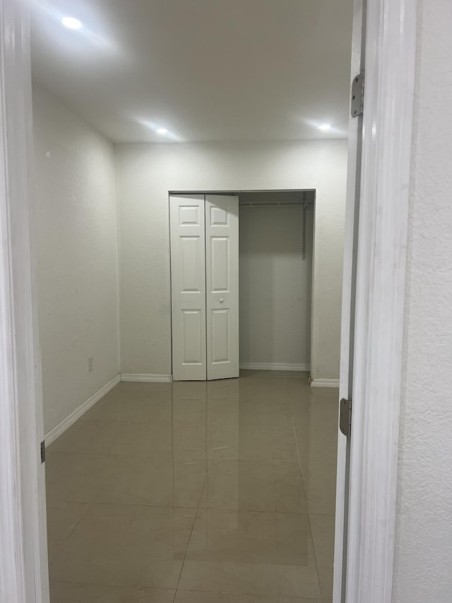 410 S D St, Lake Worth Beach, FL 33460 - unfurnished bedroom with baseboards, tile patterned flooring, and a closet