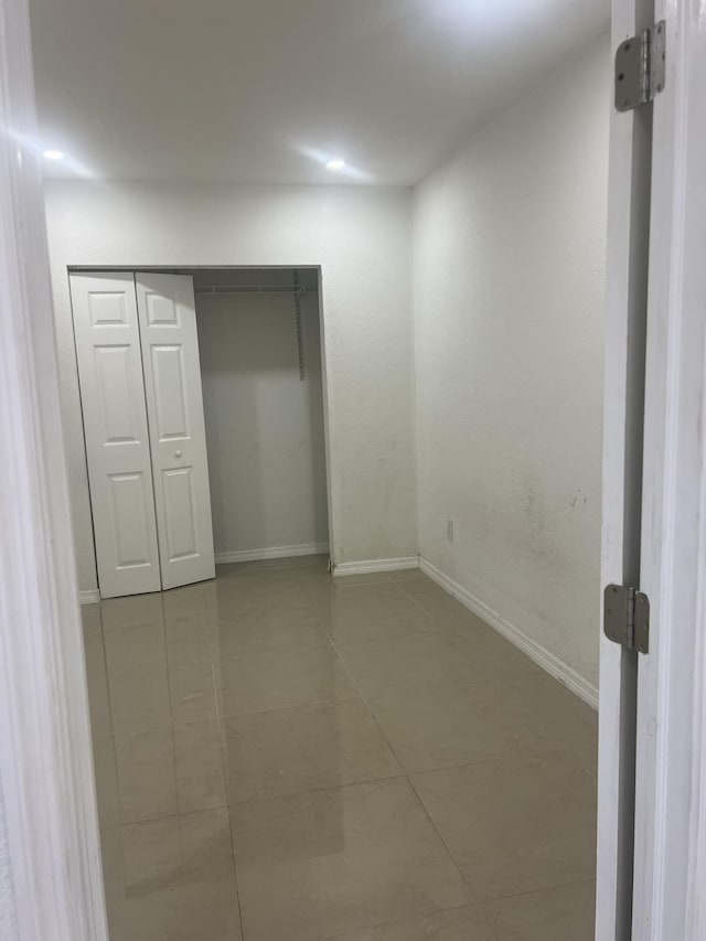 410 S D St, Lake Worth Beach, FL 33460 - unfurnished bedroom featuring baseboards, a closet, and tile patterned floors