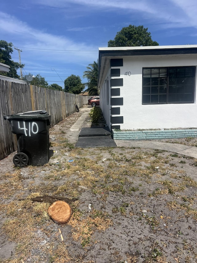 410 S D St, Lake Worth Beach, FL 33460 - view of side of property featuring stucco siding and fence