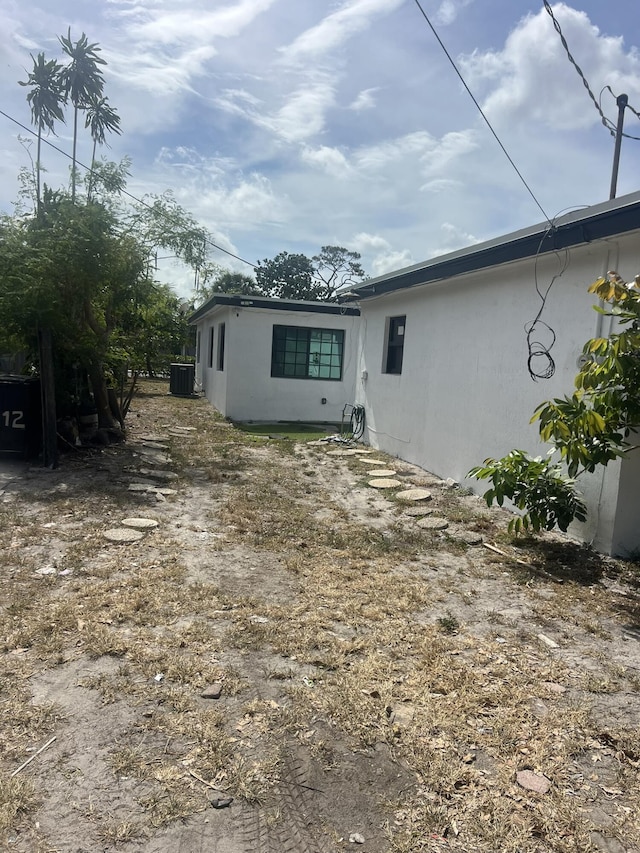 410 S D St, Lake Worth Beach, FL 33460 - rear view of house featuring central air condition unit and stucco siding
