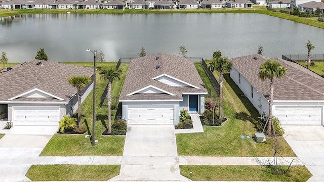 drone / aerial view with a water view and a residential view