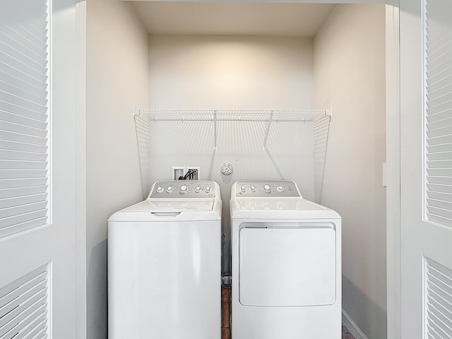 clothes washing area featuring washing machine and dryer and laundry area