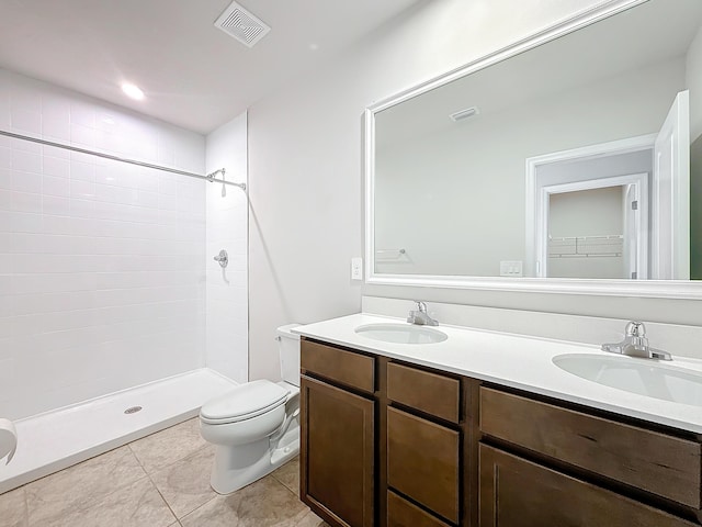 full bath with visible vents, double vanity, a sink, and toilet