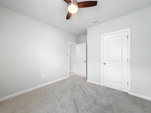 unfurnished bedroom featuring carpet, baseboards, visible vents, and a ceiling fan