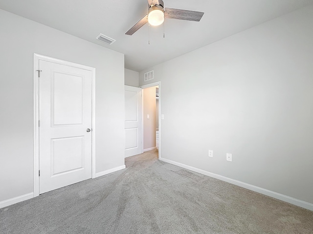 unfurnished bedroom with ceiling fan, carpet floors, visible vents, and baseboards