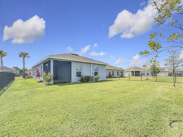 view of yard featuring a fenced backyard and a sunroom