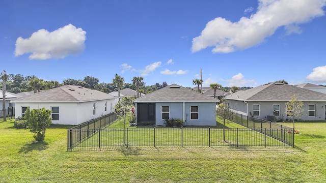 rear view of house featuring a fenced backyard, a lawn, and stucco siding