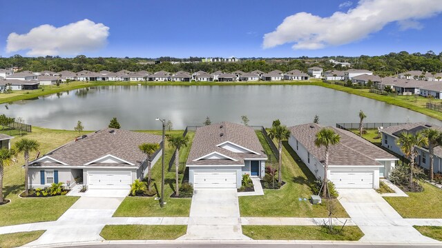 drone / aerial view with a water view and a residential view