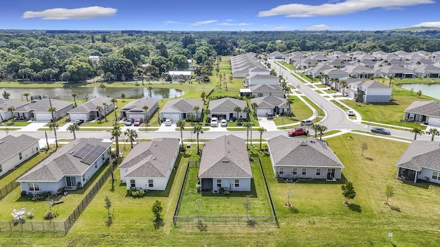 drone / aerial view with a water view and a residential view