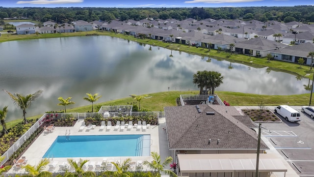 drone / aerial view featuring a residential view and a water view