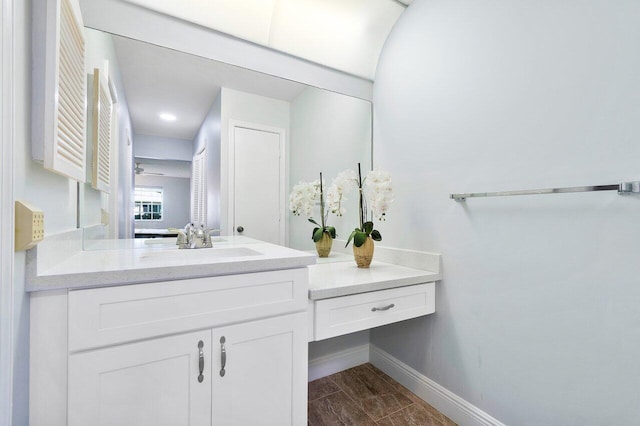 bathroom featuring wood tiled floor, baseboards, and vanity