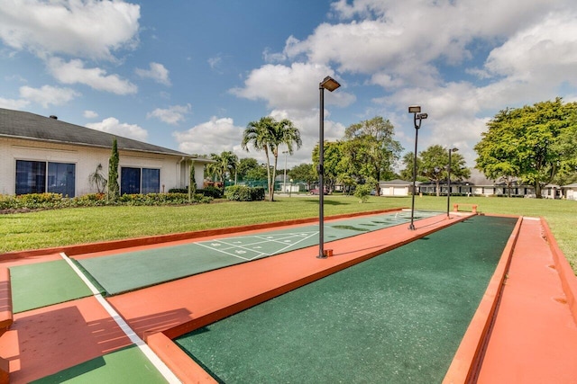 view of home's community featuring a yard and shuffleboard