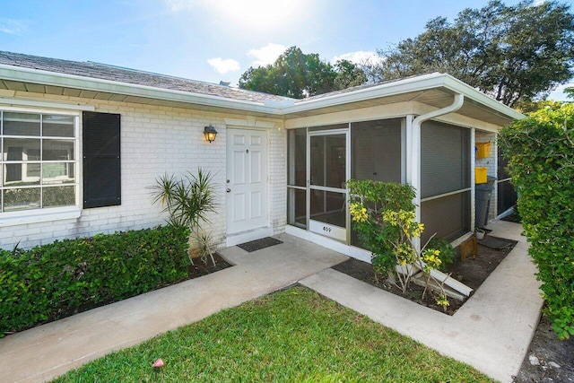 doorway to property with brick siding