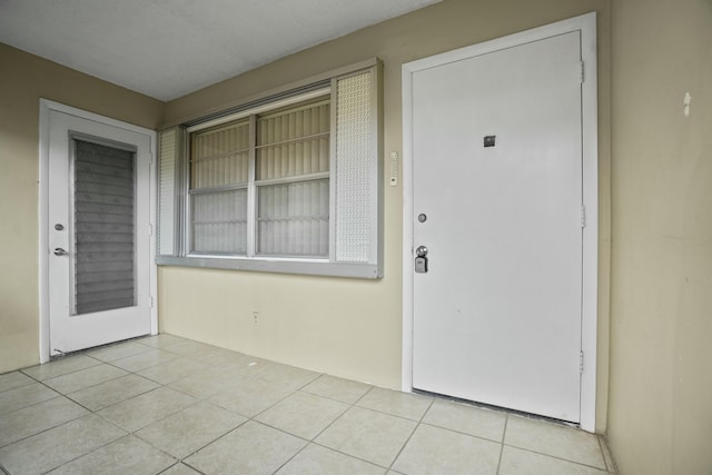 property entrance with stucco siding