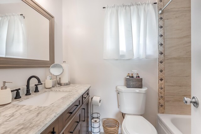 bathroom featuring  shower combination, vanity, and toilet