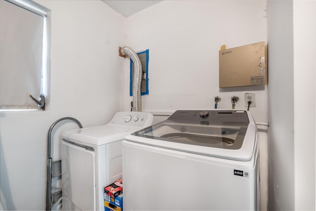 washroom featuring laundry area and washing machine and clothes dryer