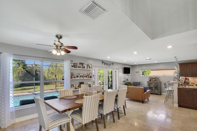 dining room featuring baseboards, visible vents, stone tile flooring, french doors, and recessed lighting