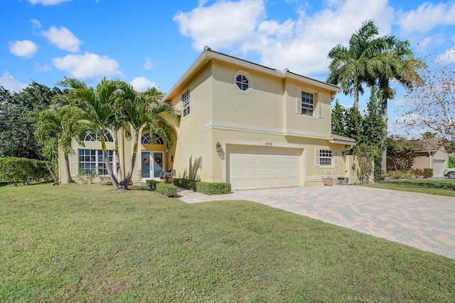 view of front of house featuring an attached garage, a front lawn, decorative driveway, and stucco siding