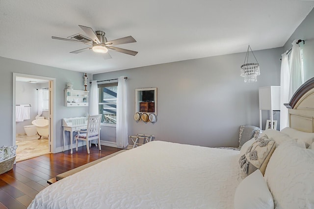 bedroom with baseboards, ceiling fan with notable chandelier, wood finished floors, and ensuite bathroom