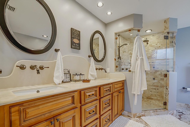 full bathroom with a stall shower, a sink, and double vanity