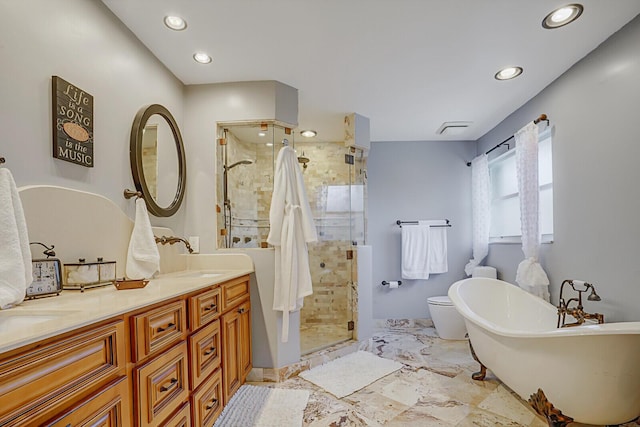 bathroom featuring a freestanding tub, recessed lighting, a sink, a shower stall, and double vanity