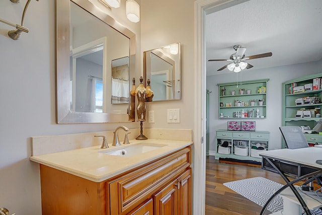 bathroom with ceiling fan, wood finished floors, and vanity